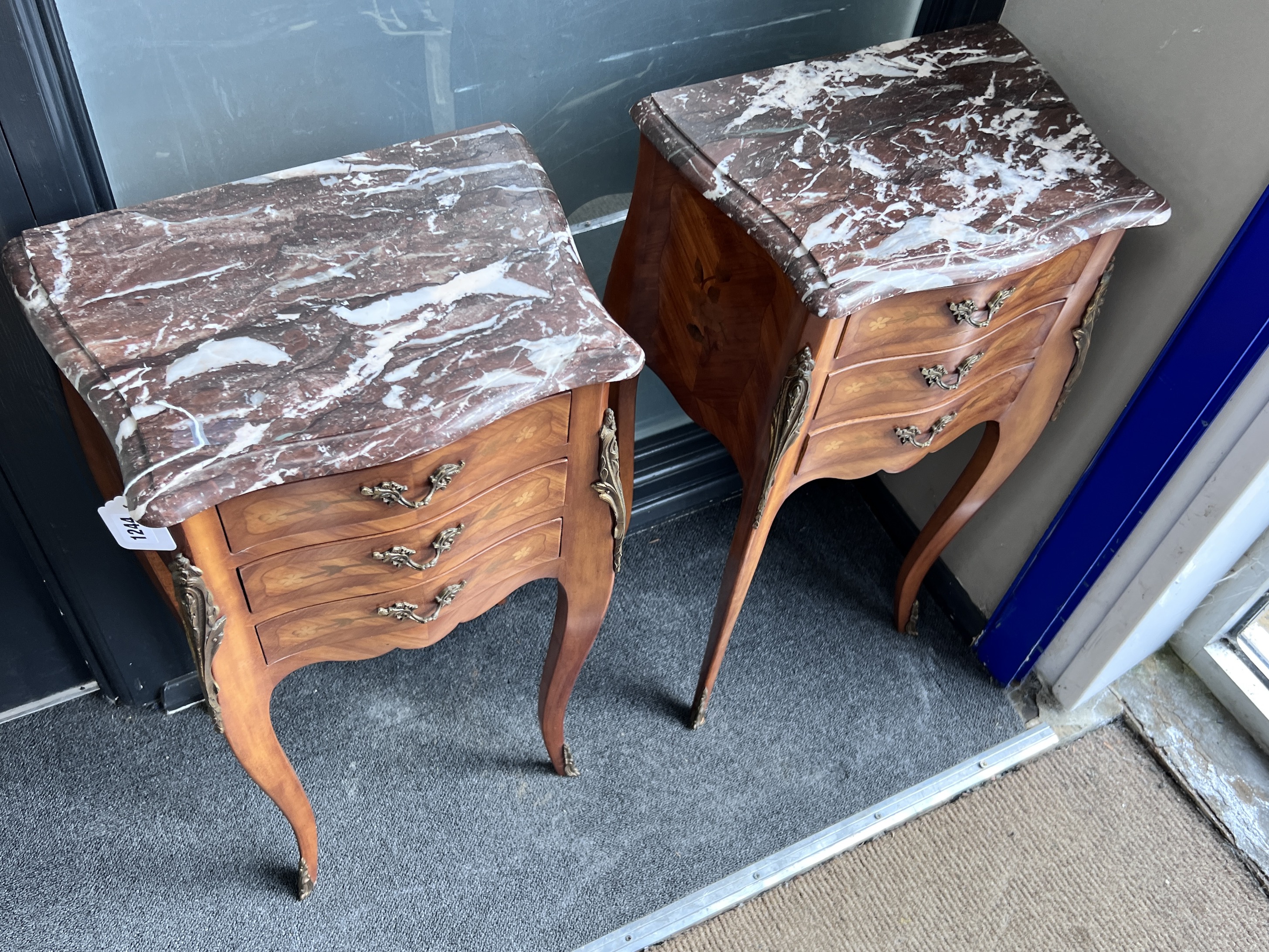 A pair of French Louis XV style marquetry inlaid serpentine rouge marble topped bedside cabinets, width 40cm, height 72cm